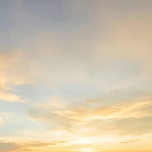 Golden Hour Sky Background with Light Clouds
