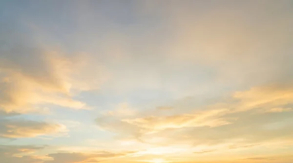 Golden Hour Sky Background with Light Clouds